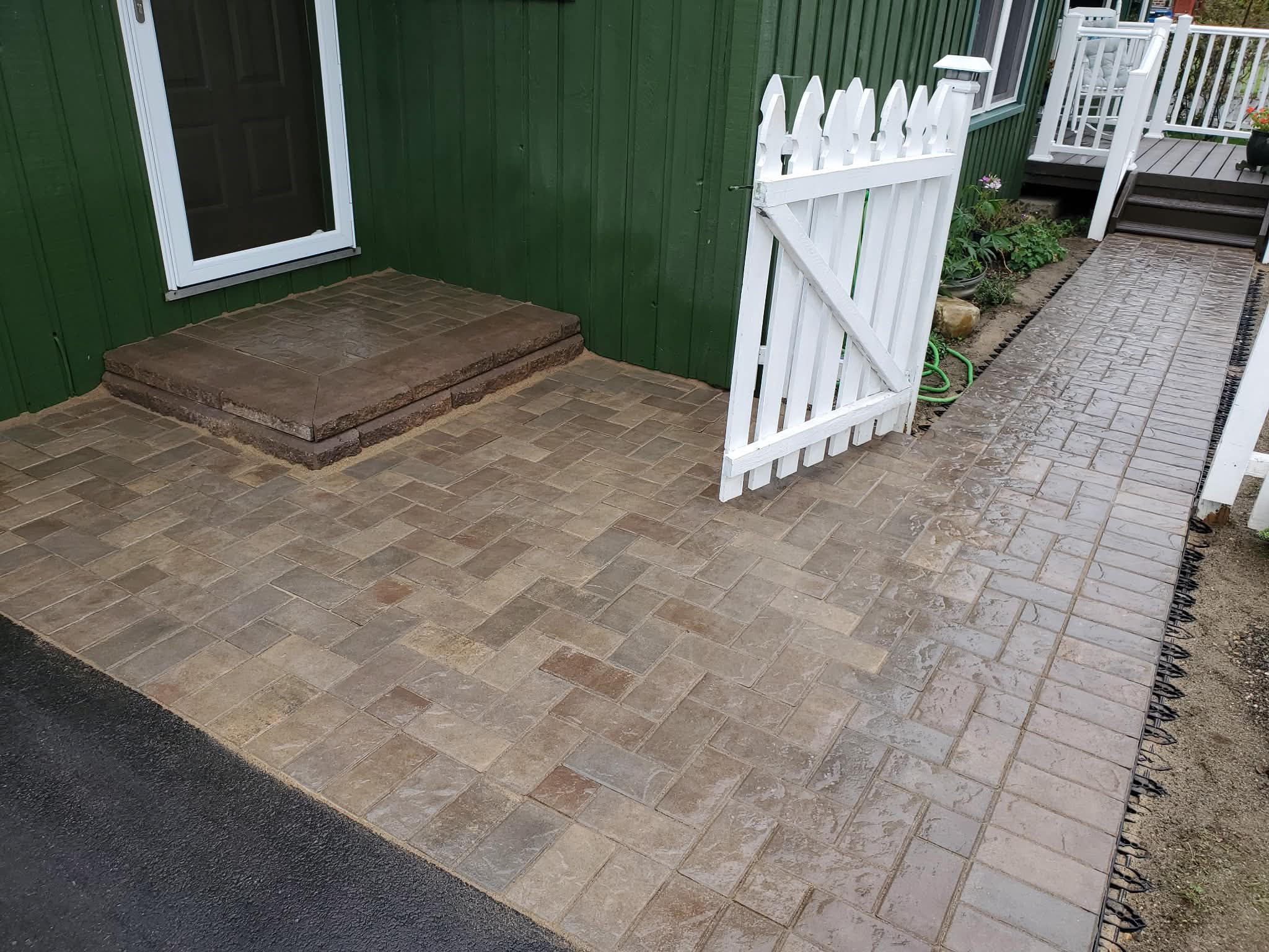 Paver patio with steps and picket fence